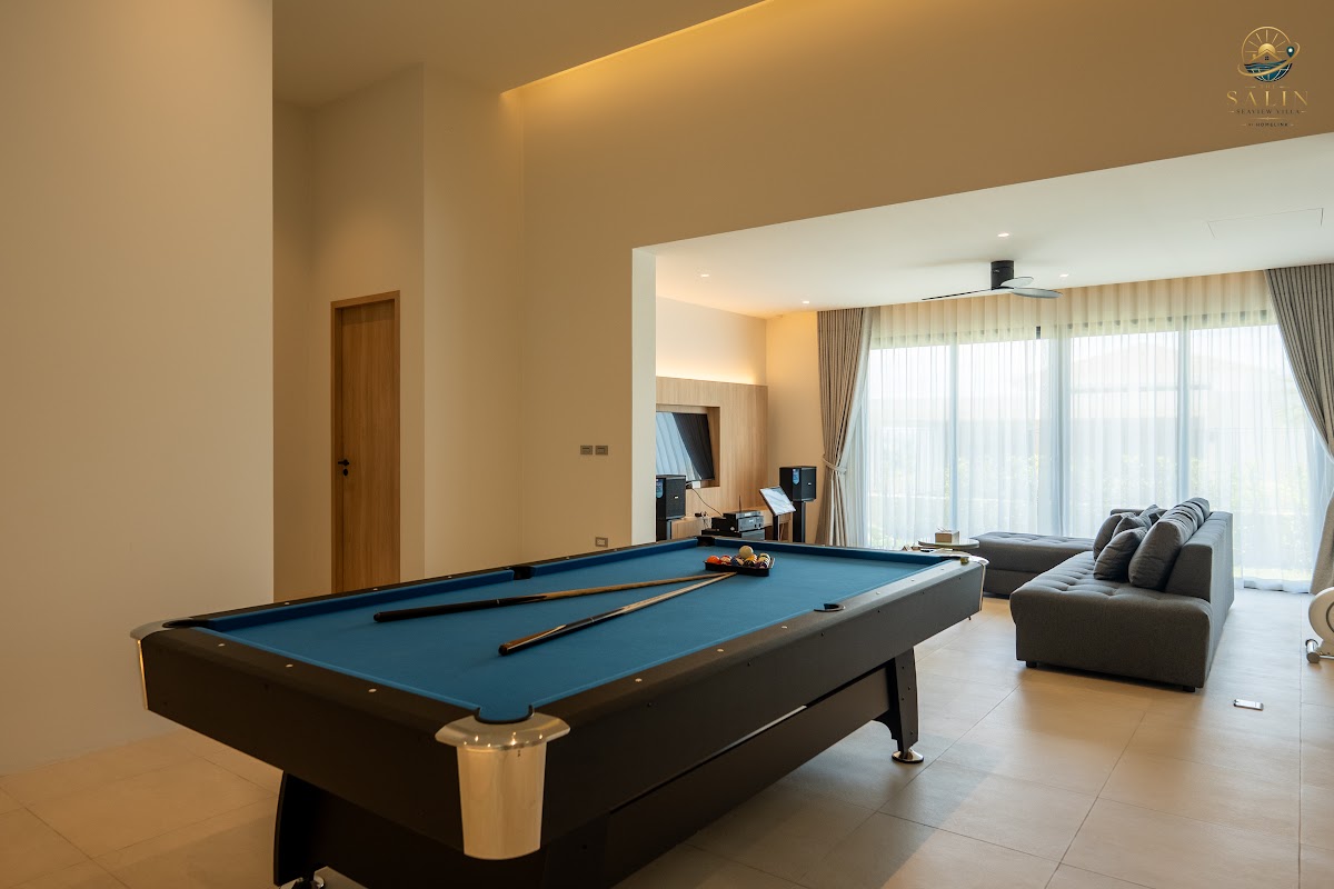 Games room with pool table and lounge seating