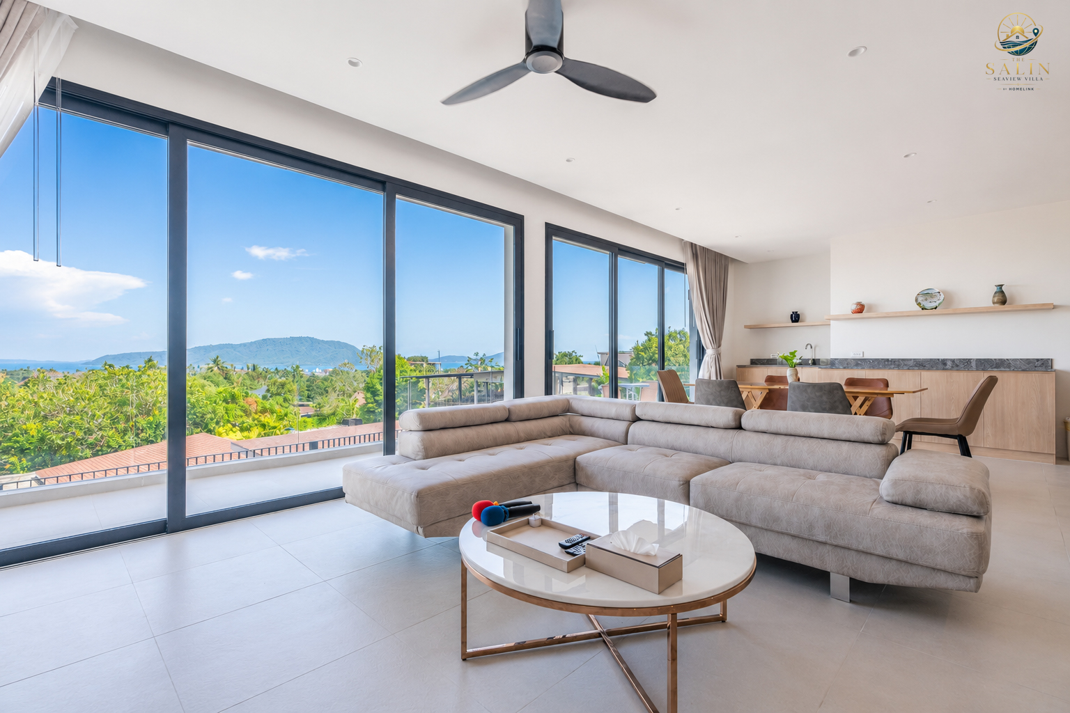 Spacious living room opening to the pool terrace and ocean view