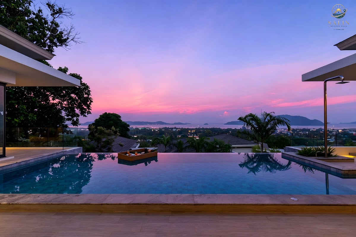 Wide view of a private infinity pool overlooking the Andaman Sea at dusk