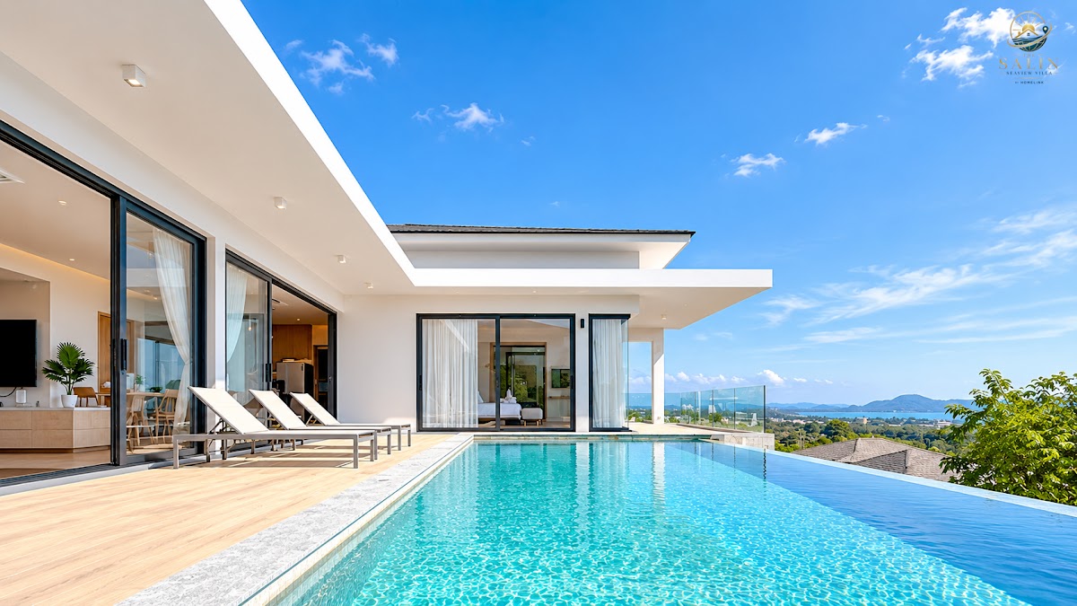Turquoise infinity pool and sun deck under a blue Phuket sky